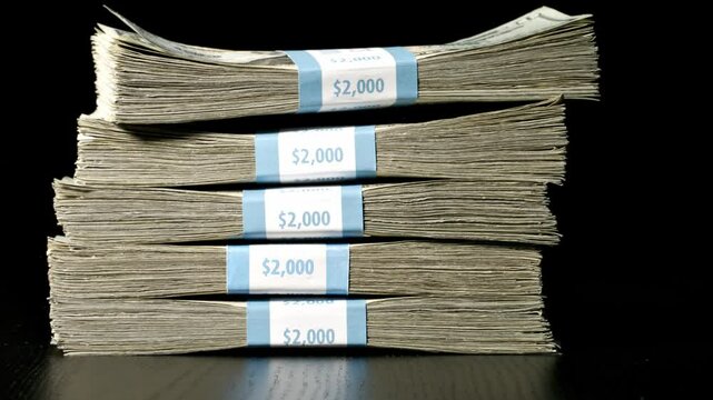 Stack of money falling and landing on a table. Slow Motion.