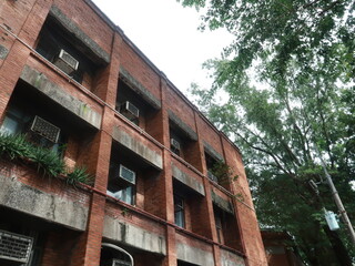 Red Brick Building with Balconies and Air Conditioners