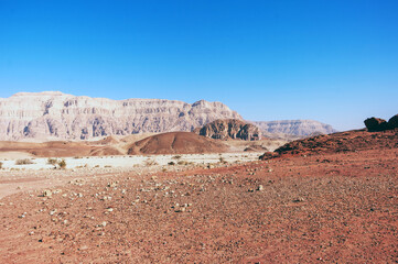 A desert landscape with a blue sky in the background