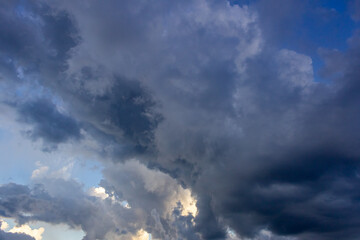 Dramatic sky with dark clouds at sunset, natural background.