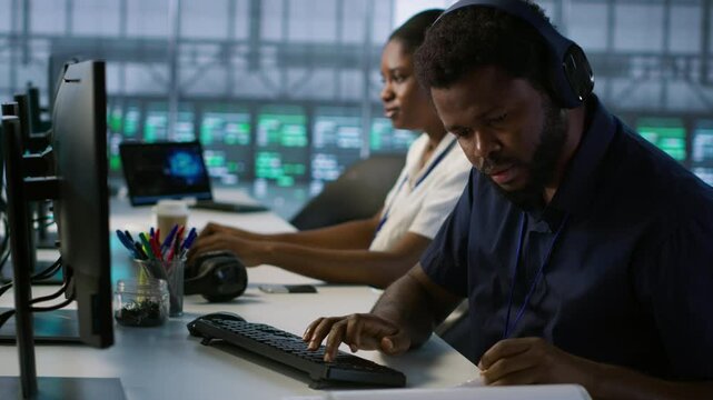 Engineer in server room looking over documents, developing disaster recovery plans ensuring minimal downtime. Worker reading paperwork in data center, using analytics to monitor performance, camera A
