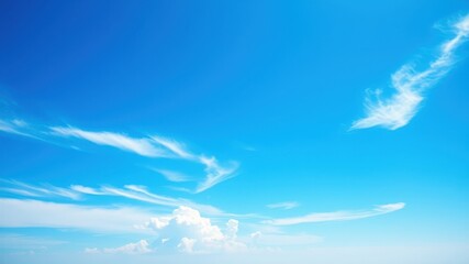 A vast blue sky with delicate white wispy clouds creating a serene and tranquil atmosphere
