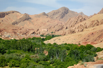 Fototapeta premium Desolate valley village and green farmland oasis Atlas Mountains Morocco