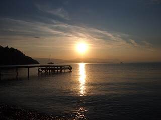 Obraz premium Sunrise behind mountains in Corfu, Greece