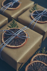 Gifts boxes in golden paper with dry oranges