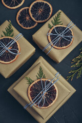 Gifts boxes in golden paper with dry oranges