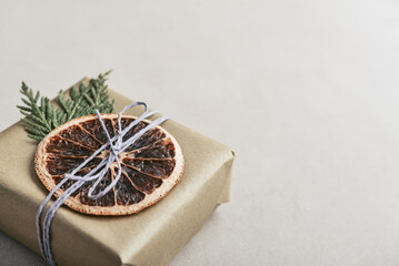 Gifts boxes in golden paper with dry oranges