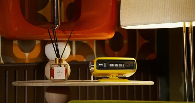 The living room is in a retro style. A digital clock on the dresser. The bright interior of the eighties