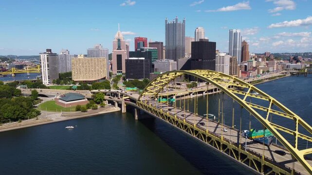A captivating aerial view of Pittsburgh, PA, captured by a drone. This footage offers a sweeping view of the city's iconic skyline while passing over the famous George Westinghouse bridge.