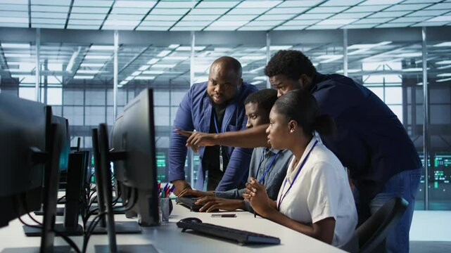 Teamworking engineers talking in server room, developing disaster recovery plans ensuring minimal downtime. Team of data center employees doing brainstorming, monitoring performance, camera A