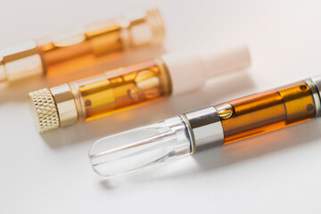 Cannabis distillate in variety of vaporizor cartridges on whte background
