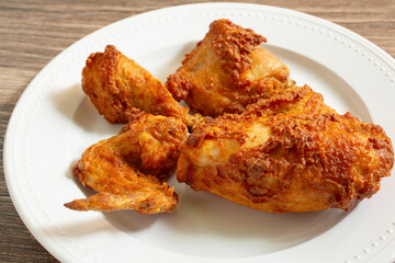 A view of a plate of deep fried chicken.