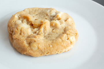 A closeup view of macadamia white chocolate cookie.