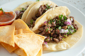 A view of a plate of carne asada tacos.