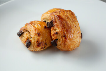 A closeup view of some mini pain au chocolat pastries.