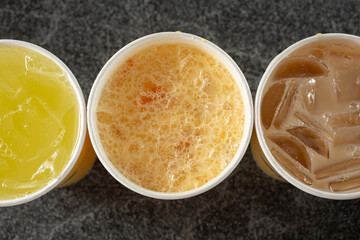 A top down view of cups of assorted aguas frescas.