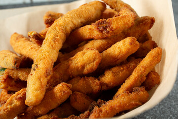 A closeup view of a basket of zucchini fries.