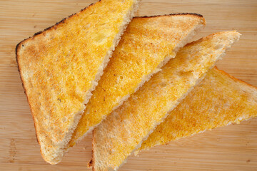 A top down view of slices of buttered toast.