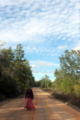 woman walking on a dirt road