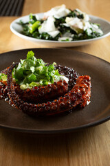 A view of a gourmet octopus tentacle entree.