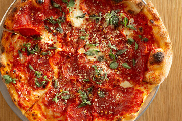 A top down view of a soppressata pizza.