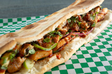 A closeup view of a pork iki bir shawarma.