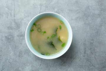 A top down view of a bowl of miso soup.