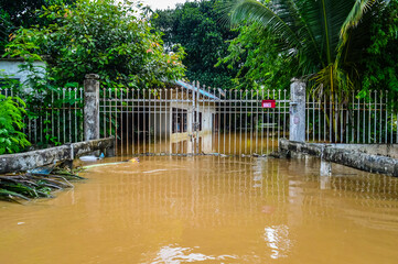 Naklejka premium The rainy season causes flooding and wild waters to houses in Thailand
