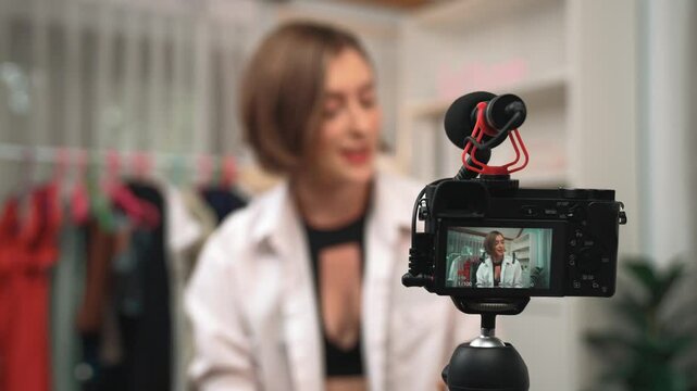 Rear view behide camera screen display influencer shoot live streaming vlog video review makeup prim social media or blog. Girl with cosmetics studio lighting for marketing recording session online.