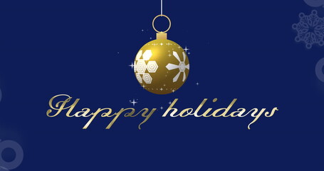 Image of happy holidays text over and christmas bauble on blue background