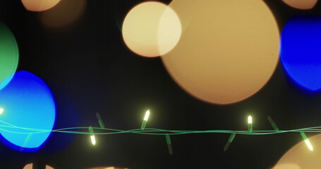 Image of flickering fairy lights over spots of light background