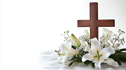 Wooden cross surrounded by white lilies and greenery, symbolizing Easter with copy space for text © Margarita