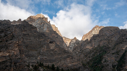morning sun light illuminates rocky himalayan peaks in Uttarakhand, India