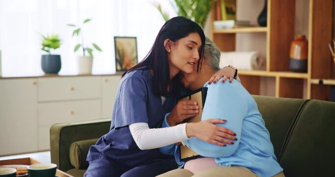 Senior care, nurse and sad woman on sofa with empathy, support and embrace in comfort at nursing home. Homecare, widow and caregiver on couch with photograph, grief counseling and hug in living room