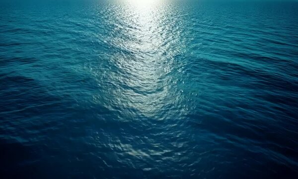 A serene view of ocean water reflecting sunlight, creating a tranquil atmosphere. The image captures the beauty and depth of the sea, inviting contemplation and relaxation.