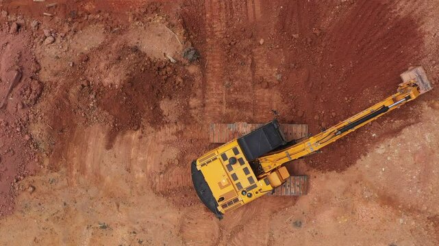Aerial view road motor grader flatting dirt road surface, Motor grader road construction grader industrial machine construction site new road, Aerial view group excavator working on construction site.