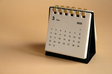 Monthly calendar template for the new year 2025 desk calendar,isolated on Beige background.