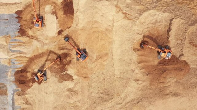 Aerial view road motor grader flatting dirt road surface, Motor grader road construction grader industrial machine construction site new road, Aerial view group excavator working on construction site.