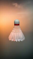 Badminton shuttlecock mid-flight against textured gray overcast sky