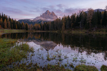 Stunning landscape and Tri Cime reflection of Antorno lake in autumn, Dolomite Italy.