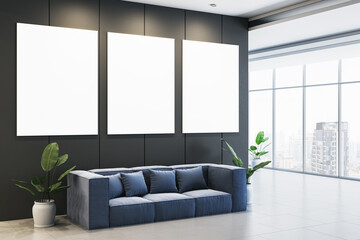 Modern office waiting area with blank vertical posters on dark wall, blue sofa, and green plants near large windows in urban setting. 3D Rendering