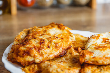 cooked chicken chops on a white plate on the table