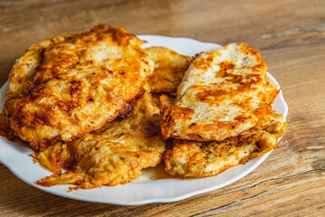 cooked chicken chops on a white plate on the table