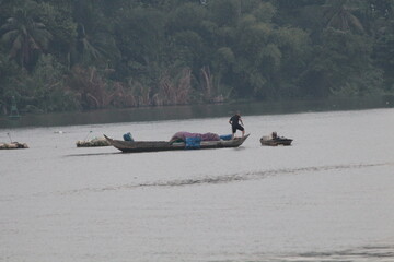 A traditional boat/ferry on the river in Vietnam in the afternoon. 