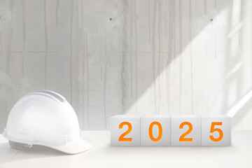 Happy New Year 2025 for construction industry. Construction worker prepares to celebrate the new year on the engineer's desk .