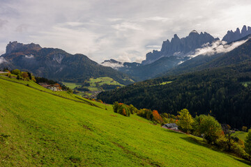 Fototapeta premium The specular landscape when you drive at Val di Funes area in Autumn season, Dolomite, Italy.