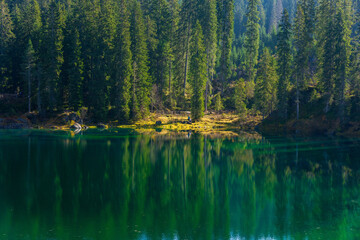 Stunning landscape and reflection of Karersee lake in autumn, Dolomite Italy.