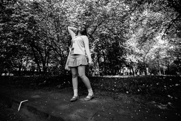 Portrait of a young beautiful girl in the summer in an urban environment. Black and white photo.