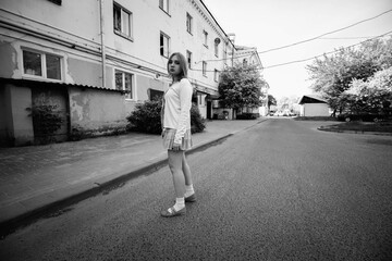 Portrait of a young beautiful girl in the summer in an urban environment. Black and white photo.