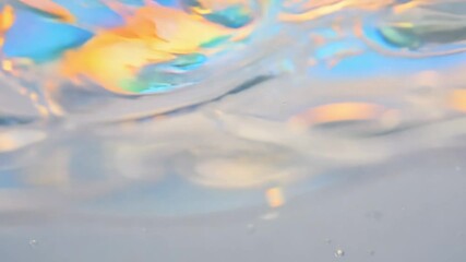 Seamless loop video of soap bubbles floating on water with rainbow reflections. static video with soft lighting, focus on iridescent colors and delicate movements